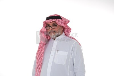 close-up of a Saudi man in traditional Saudi dress, wearing glasses, Saudi model, white background