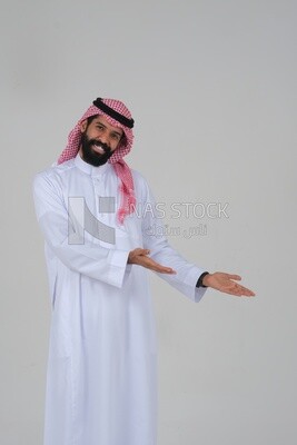 Saudi man  pointing his hand at something, facial gestures indicating happiness, pointing towards something, white background, Saudi model