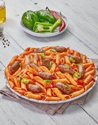 Top view of plate of pasta with sausage and appetizers