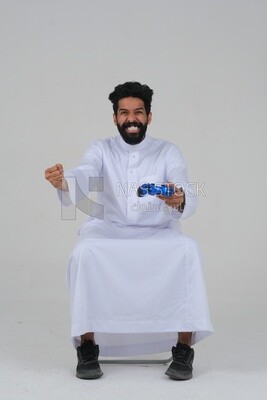 saudi  man holding a joystick in his hand and playing video games, with gestures and expressions that indicate focus and harmony, fun and entertainment with video games, PlayStation entertainment ga