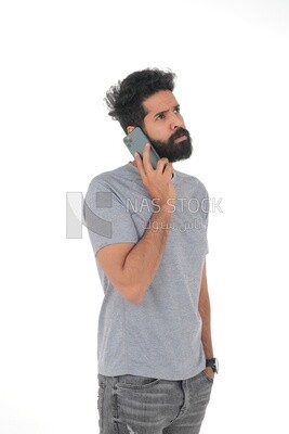 Saudi man wearing a casual drees, using a mobile phone, communicating with individuals, online requests and marketing, social relations, using technical devices, white background