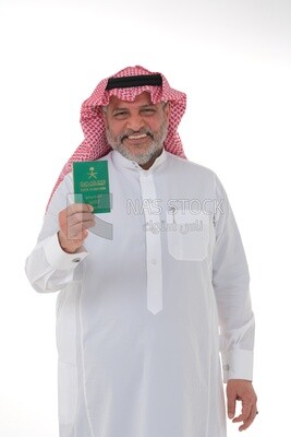 elderly Saudi man holding a Saudi passport with gestures of happiness, official documents, international travel of Saudi citizens, Saudi National Day, National Day celebration, white background