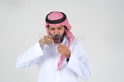 old Saudi man wearing a white dress, drinking a cup of tea, self-confidence, white background, Saudi model