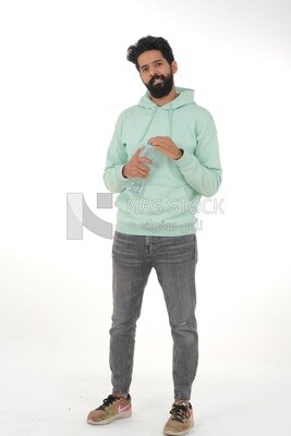 Saudi man wearing casual clothes, drinking from a water bottle, Saudi model, white background