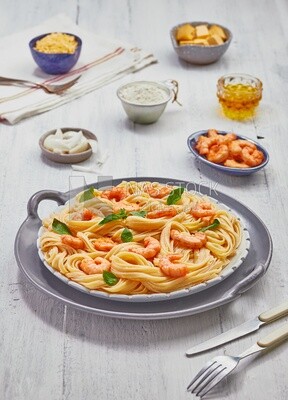 Dining table with spaghetti and shrimp