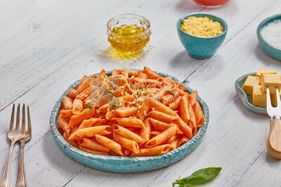 Dining table with a plate of pasta in red sauce