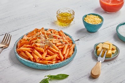 Dining table with a plate of pasta in red sauce and appetizers