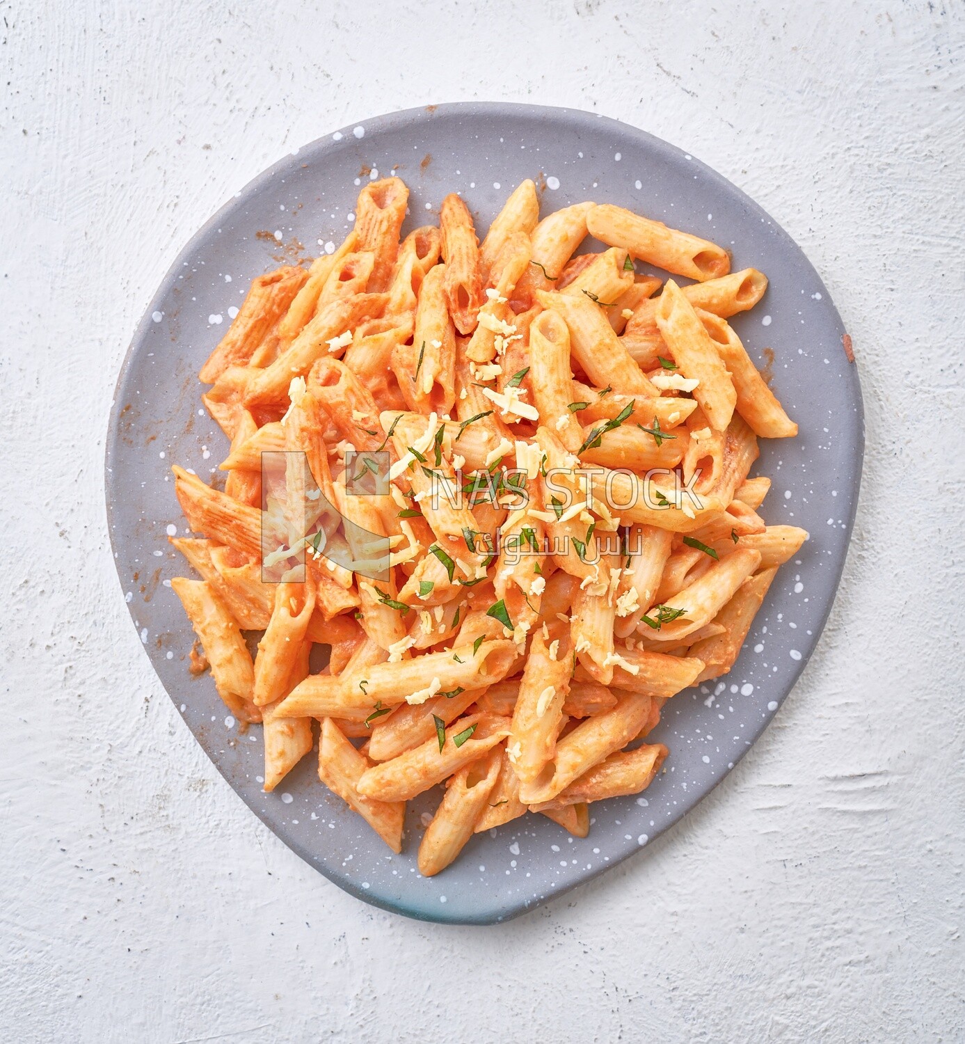 Plate of pasta with grated cheese and parsley