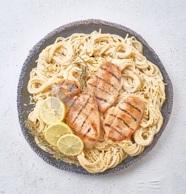 Top view of a plate of spaghetti  with chicken