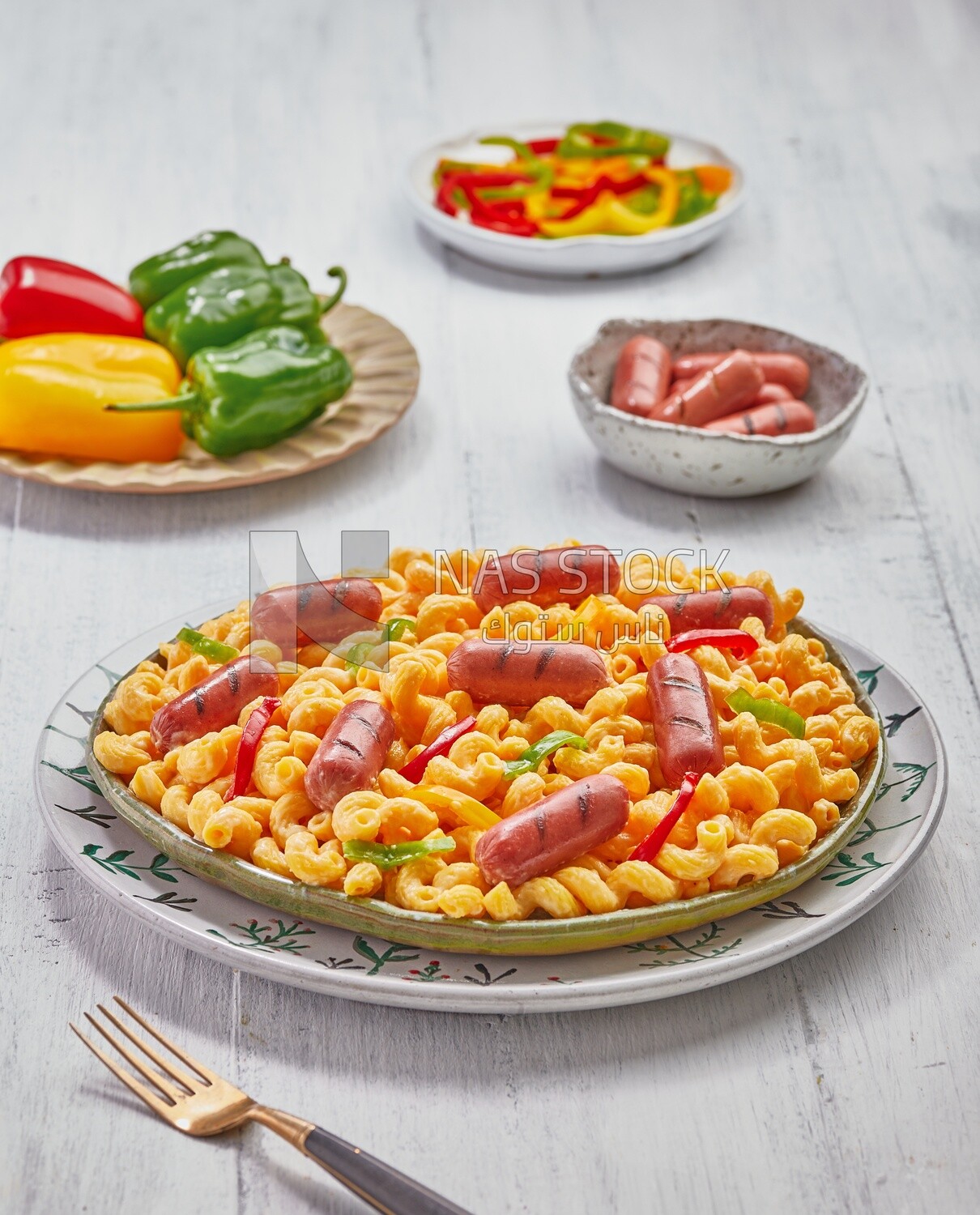 Side view plate of pasta with sausage and appetizers