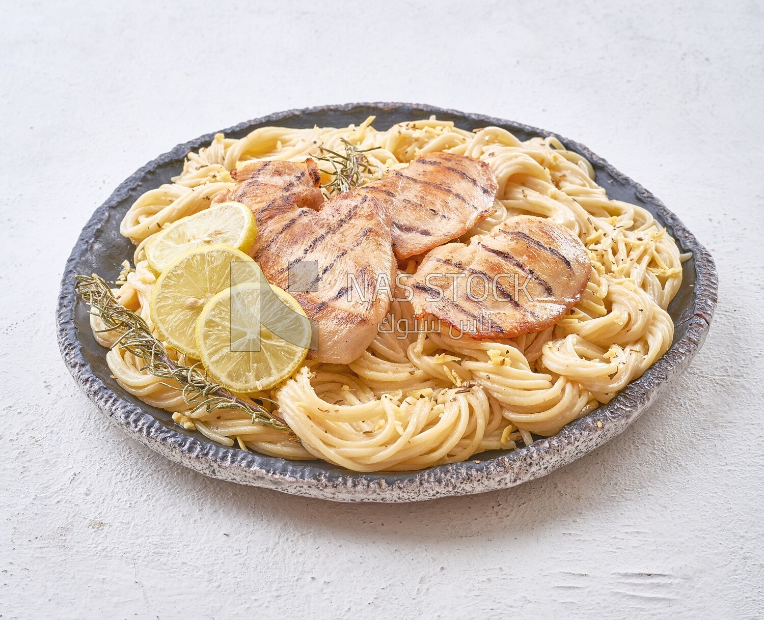 Plate of spaghetti  with chicken and lemon