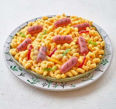 Plate of pasta with sausage on a solid background