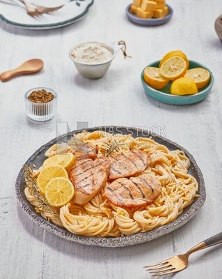 Plate of spaghetti pasta with chicken and appetizers