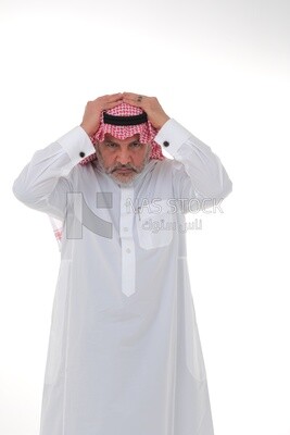 elderly Saudi man with his hands on his head, feeling pain and headache, wearing a white dress with a shemagh and headband, white background, an elderly man with pain in his head, the concept of bo
