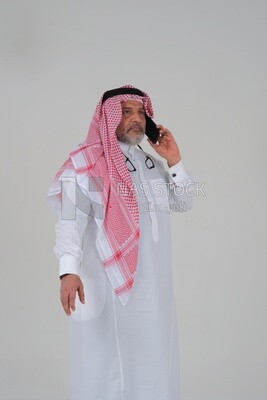 elderly Saudi man using a mobile phone, communicating with individuals, online requests and marketing, social relations, using technical devices, white background
