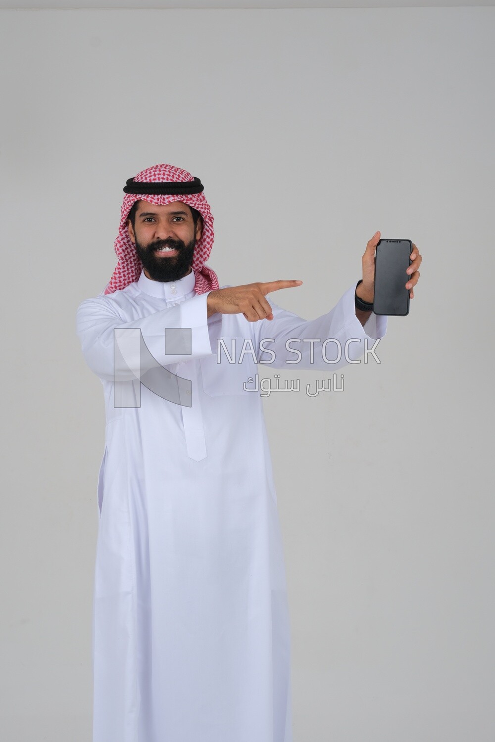 Saudi man using a mobile phone pointing on it, communicating with individuals, online requests and marketing, social relations, using technical devices, white background