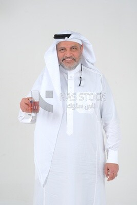 old Saudi man wearing a white dress, drinking a cup of tea, self-confidence, white background, Saudi model