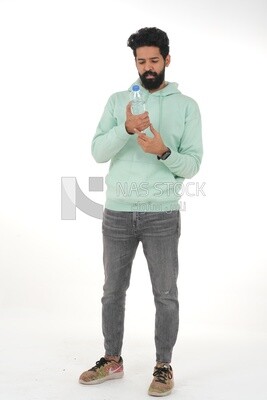 Saudi man wearing casual clothes, drinking from a water bottle, Saudi model, white background
