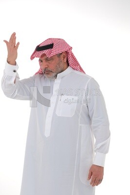 elderly Saudi man with his hands on his head, feeling pain and headache, wearing a white dress with a shemagh and headband, white background, an elderly man with pain in his head