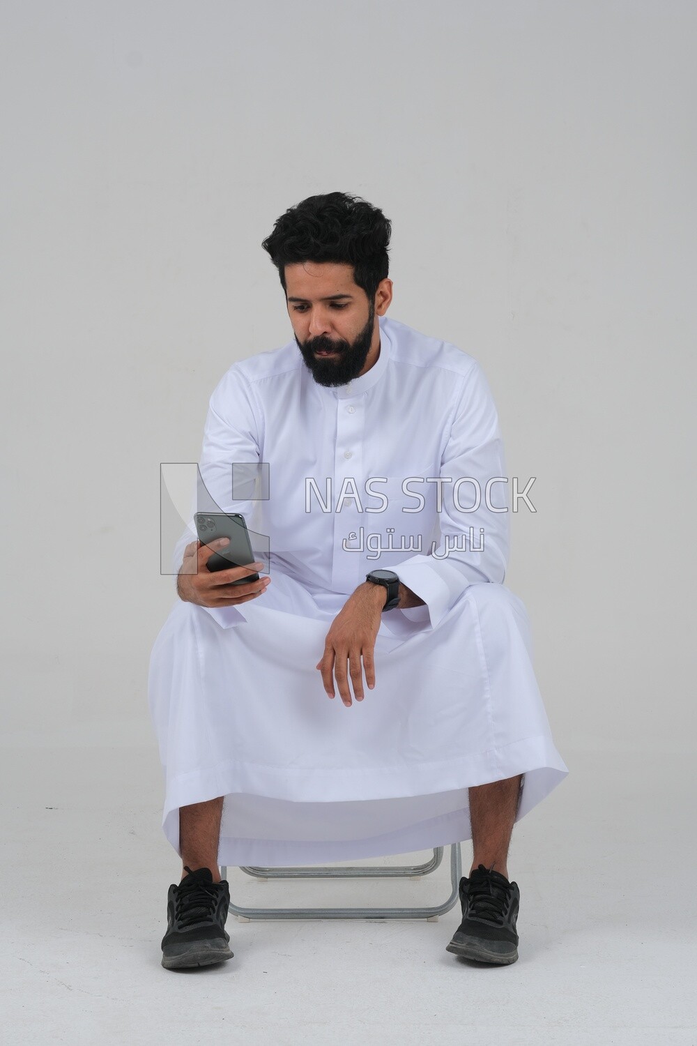 saudi man using a mobile phone, communicating with individuals, online requests and marketing, social relations, using technical devices, white background