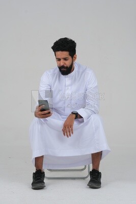 saudi man using a mobile phone, communicating with individuals, online requests and marketing, social relations, using technical devices, white background