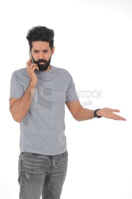 close-up of a Saudi man looking angry, wearing casual clothes, talking on his mobile phone, Saudi model, white background