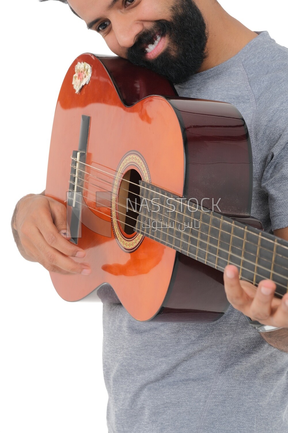 Saudi  man carrying a musical instrument, guitar playing talent, entertainment and singing, white background, Saudi model