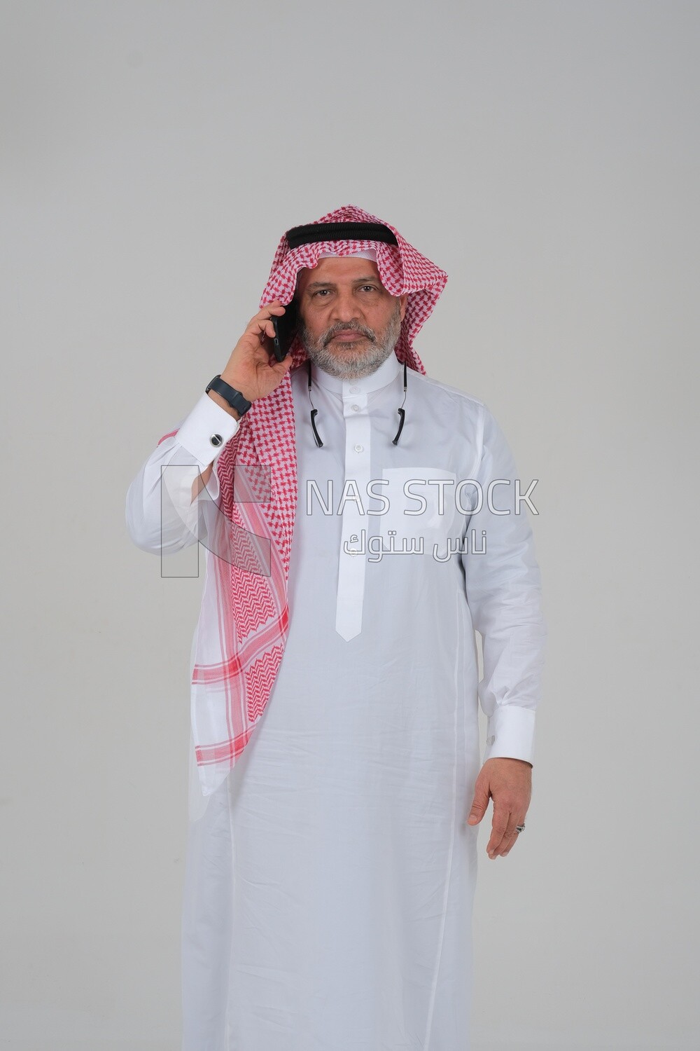 elderly Saudi man using a mobile phone, communicating with individuals, online requests and marketing, social relations, using technical devices, white background