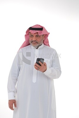 elderly Saudi man using a mobile phone, communicating with individuals, online requests and marketing, social relations, using technical devices, white background