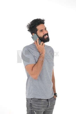 Saudi man wearing a casual drees, using a mobile phone, communicating with individuals, online requests and marketing, social relations, using technical devices, white background