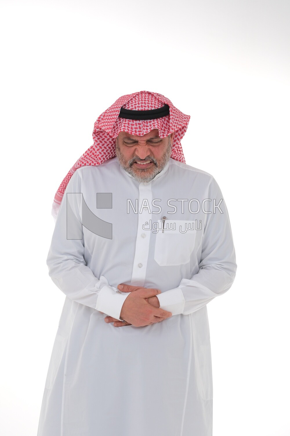 Saudi man placing his hands on his stomach,  abdominal and stomach pain, intestinal disorders, digestive system imbalance, white background