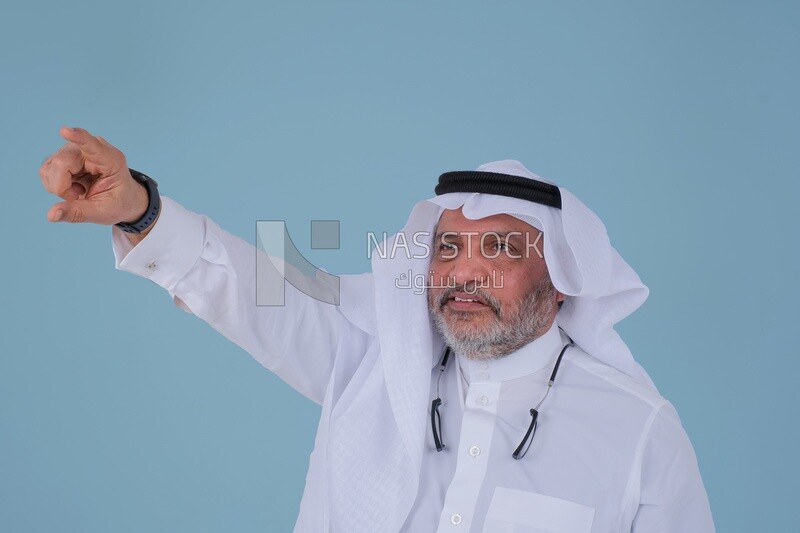 close-up of a Saudi man in traditional Saudi dress pointing away, side view, Saudi model