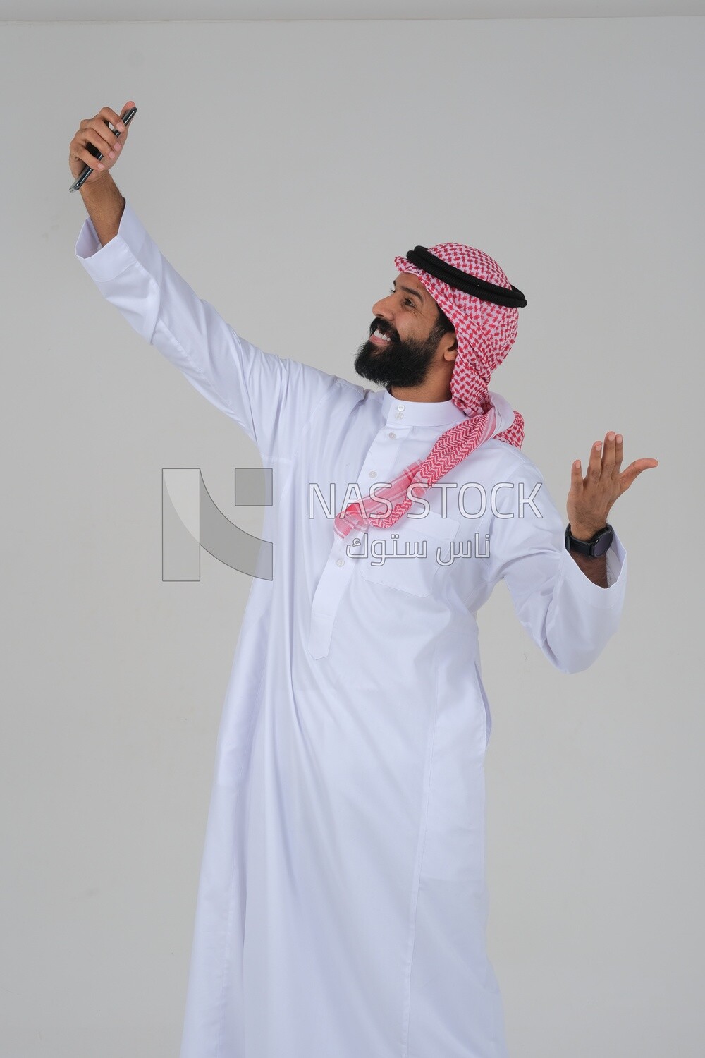 Saudi man using a mobile phone, taking a selfie, communicating with individuals, online requests and marketing, social relations, using technical devices, white background