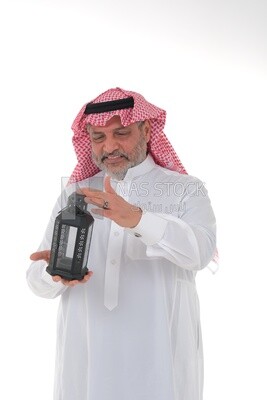 Saudi man holding a Ramadan lantern, Ramadan lantern, the blessed month of Ramadan, lighting and decorations for the month of Ramadan, Ramadan atmosphere, religious occasions