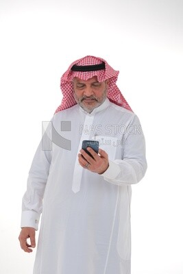 elderly Saudi man using a mobile phone, communicating with individuals, online requests and marketing, social relations, using technical devices, white background