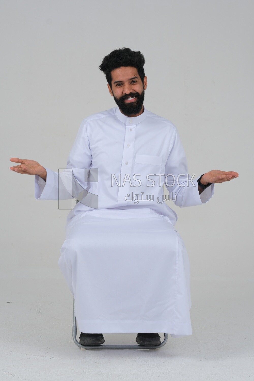 close-up of a Saudi man in traditional Saudi dress, sitting on a chair, Saudi model, white background