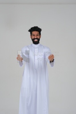 Saudi man wearing a white dress looks happy, facial gestures indicating happiness and joy, self-confidence, white background, Saudi model