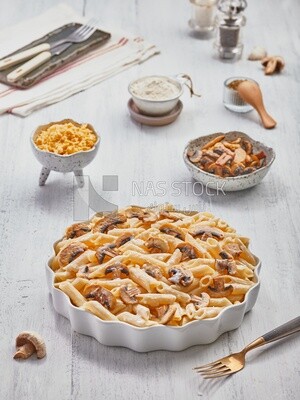 Dining table , plate of pasta with mushrooms