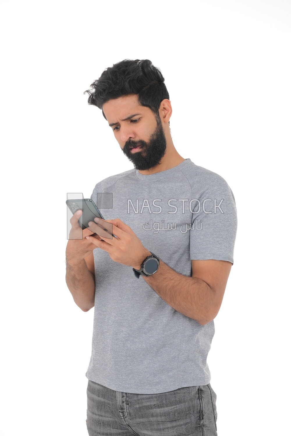 close-up of a Saudi man, wearing casual clothes, carrying his mobile phone, Saudi model, white background