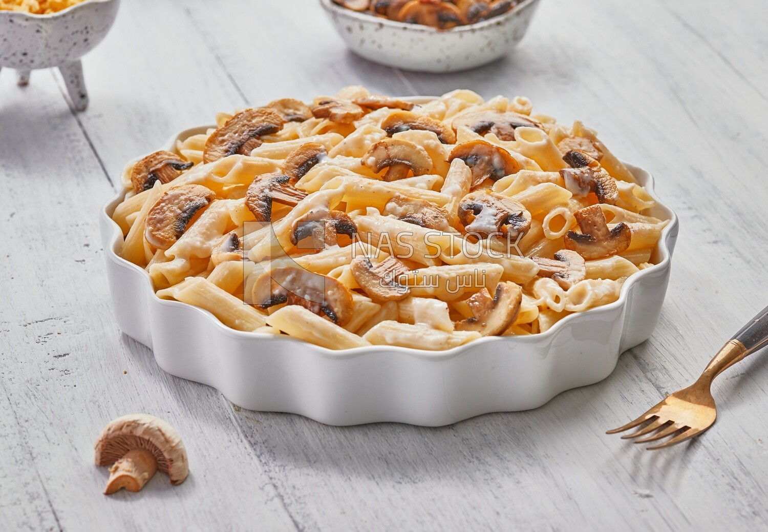 Side view of a plate of pasta with mushrooms