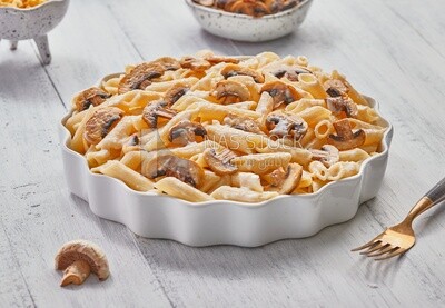 Side view of a plate of pasta with mushrooms