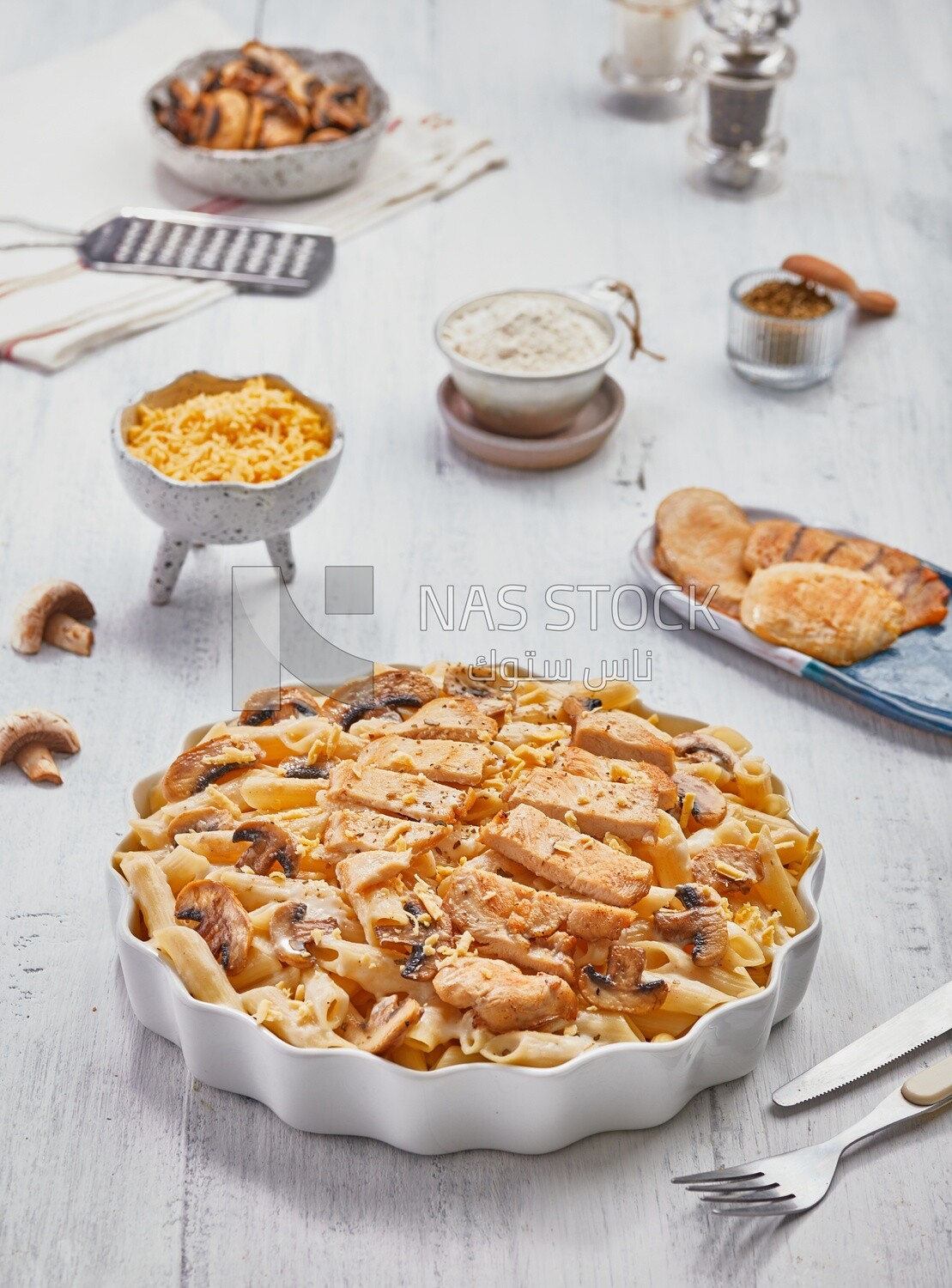 Top view of a dining table with plate of pasta with mushrooms