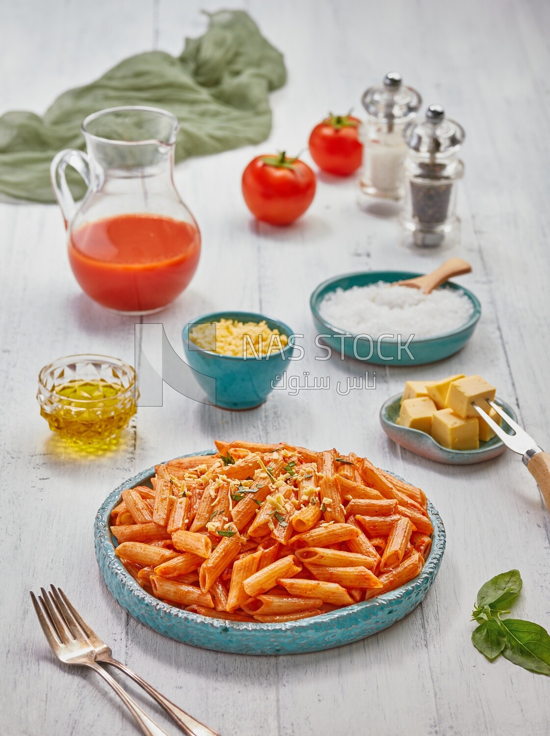 Dining table with a plate of pasta in red sauce