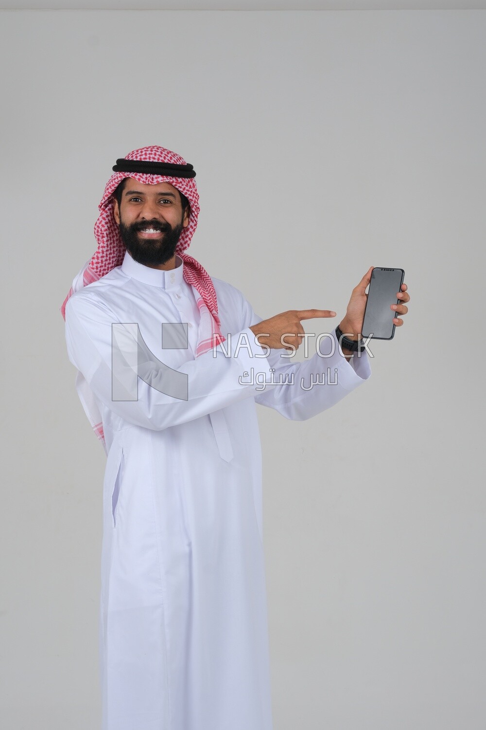 Saudi man using a mobile phone pointing on it, communicating with individuals, online requests and marketing, social relations, using technical devices, white background