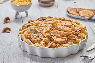 Side view of a plate of pasta with mushrooms