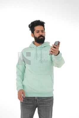 close-up of a Saudi man, wearing casual clothes, carrying his mobile phone, Saudi model, white background