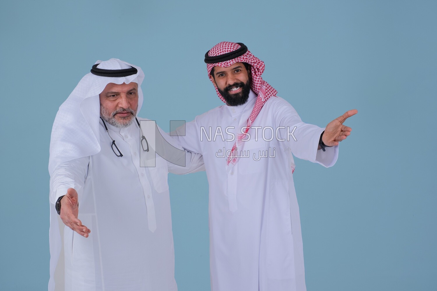 two Saudi men pointing at something, identifying a target, pointing towards something, finger movement and gestures