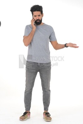 close-up of a Saudi man looking angry, wearing casual clothes, carrying his mobile phone, Saudi model, white background