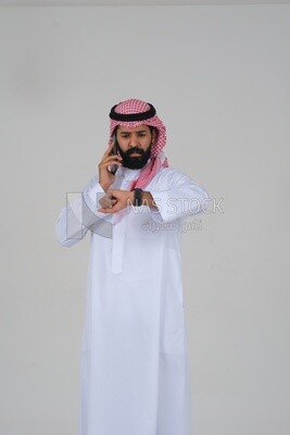Saudi man using a mobile phone, talking on the phone , communicating with individuals, online requests and marketing, social relations, using technical devices, white background