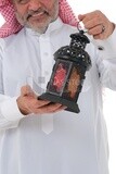 Saudi man holding a Ramadan lantern, Ramadan lantern, the blessed month of Ramadan, lighting and decorations for the month of Ramadan, Ramadan atmosphere, religious occasions